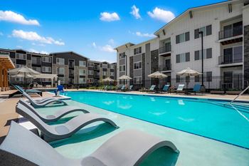 Oversized outdoor pool deck with spa, cabanas, grilling, and fire pit lounges